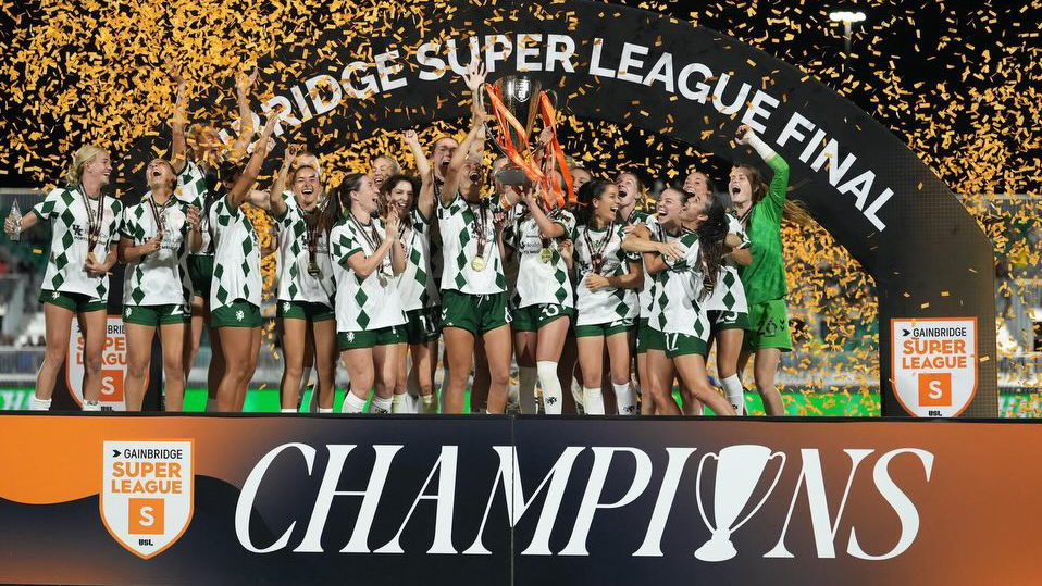 Lexington SC players lift the championship trophy